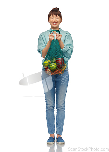 Image of happy asian woman with food in reusable string bag