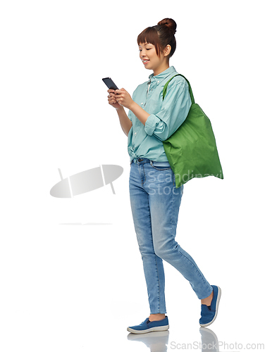 Image of woman with phone and reusable food shopping bag