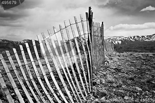 Image of old fence through mountains