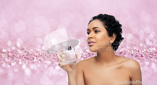 Image of young african american woman with perfume