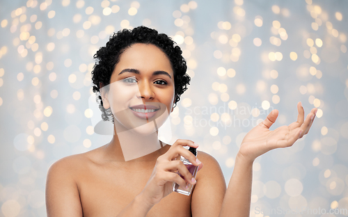 Image of young african american woman with perfume