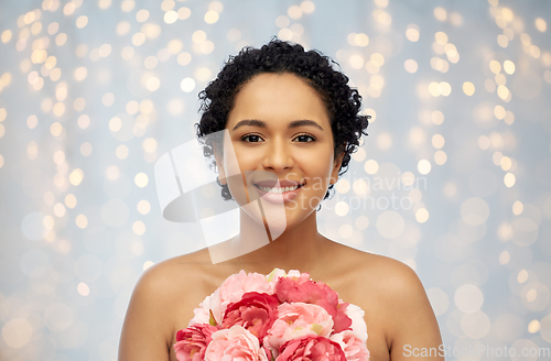 Image of portrait of african american woman with flowers