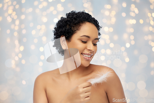 Image of happy african american woman with feather