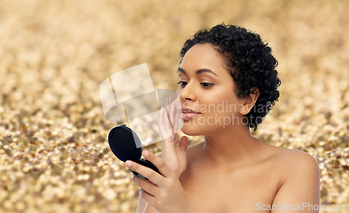 Image of african american woman looking to mirror