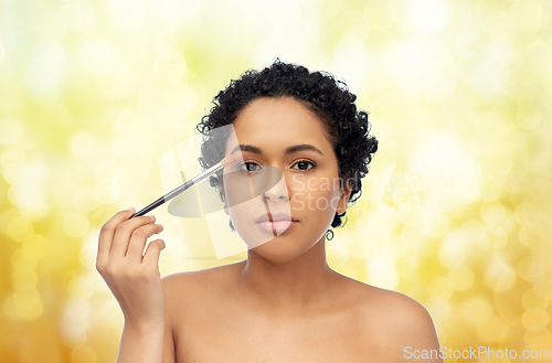Image of african american woman with make up brush