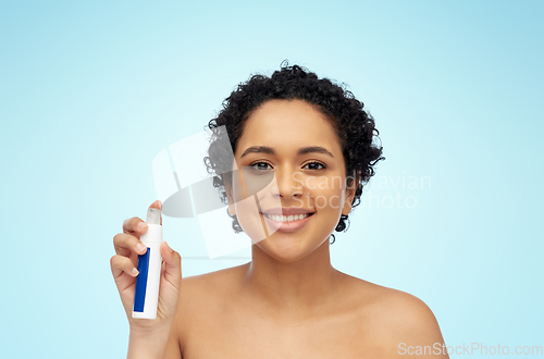 Image of happy african woman with spray bottle