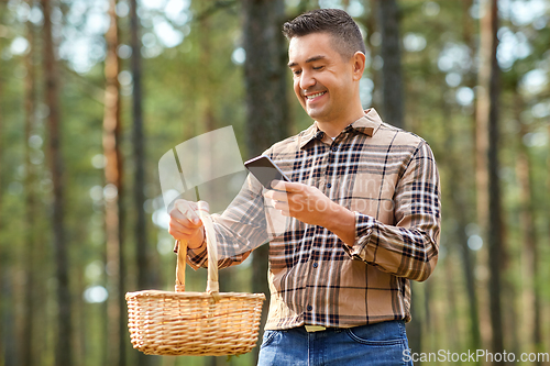 Image of man using smartphone to identify mushroom