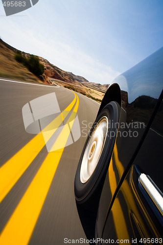 Image of car driving through mountains