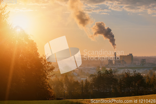 Image of industrial cityscape with with smoking factory