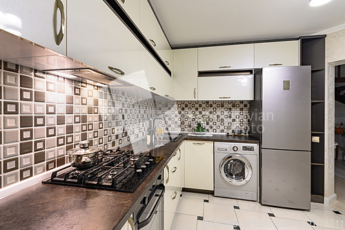 Image of Brown and white modern kitchen interior