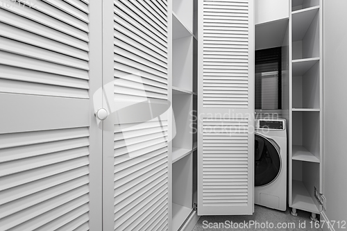 Image of White laundry room inside wardobe in new apartment