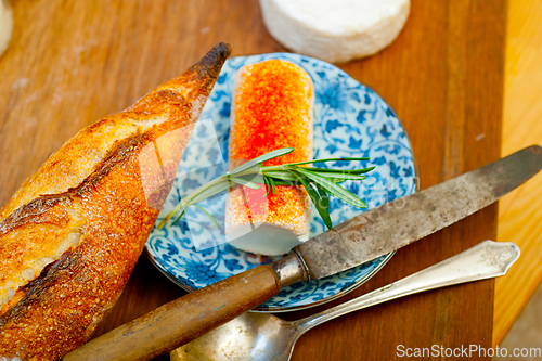 Image of French cheese and fresh  baguette on a wood cutter