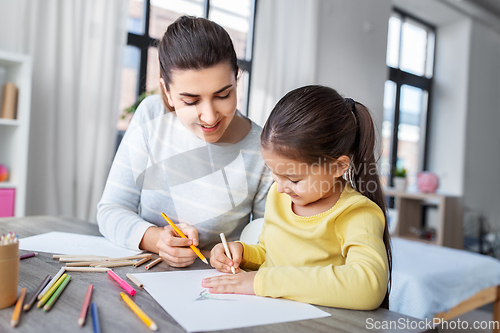 Image of mother with little daughter drawing at home