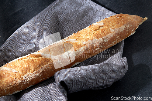 Image of close up of baguette bread on kitchen towel