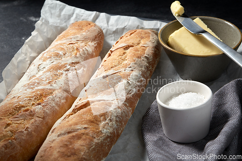 Image of close up of bread, butter and knife on towel