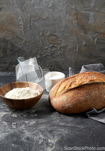 Image of bread, wheat flour, salt and water in glass jug