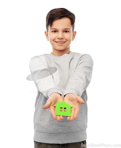 Image of smiling boy holding green house icon