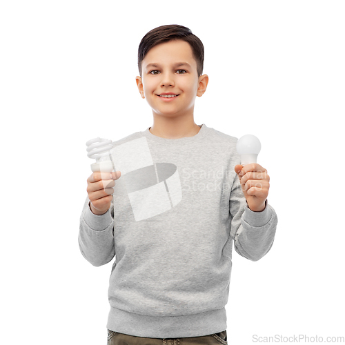 Image of smiling boy comparing different light bulbs