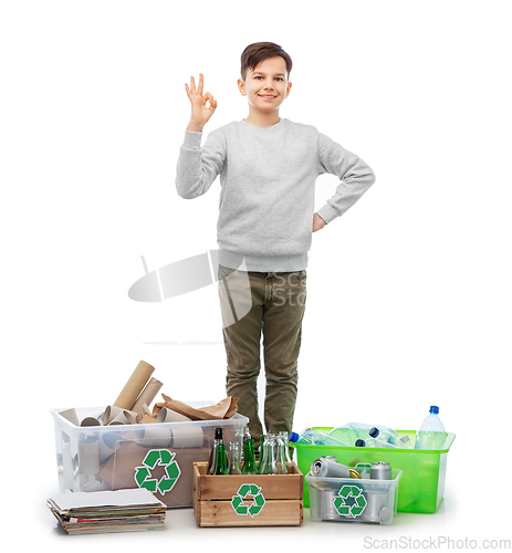 Image of smiling boy sorting paper, metal and plastic waste
