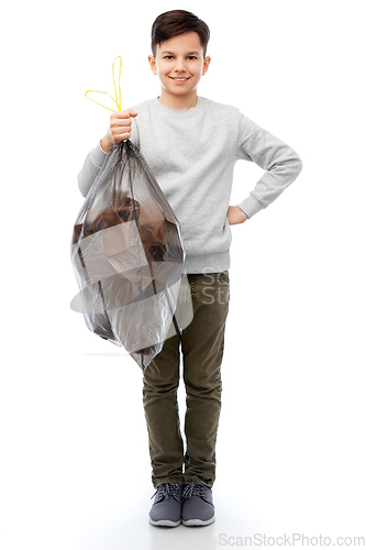 Image of smiling boy with paper garbage in plastic bag