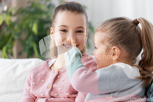 Image of two happy smiling little girls or sisters at home