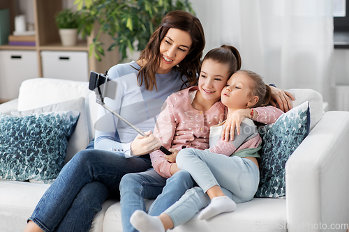 Image of happy family taking selfie by smartphone at home