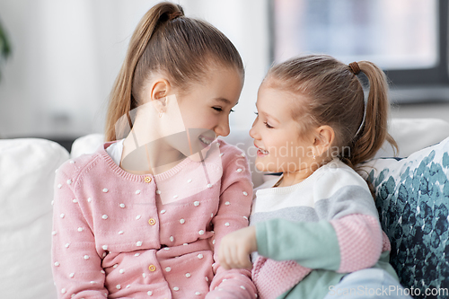 Image of two happy smiling little girls or sisters at home