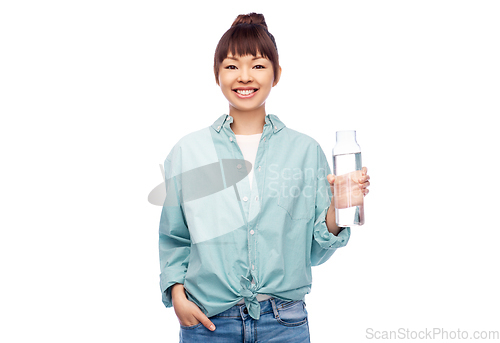 Image of happy asian woman holding glass bottle with water