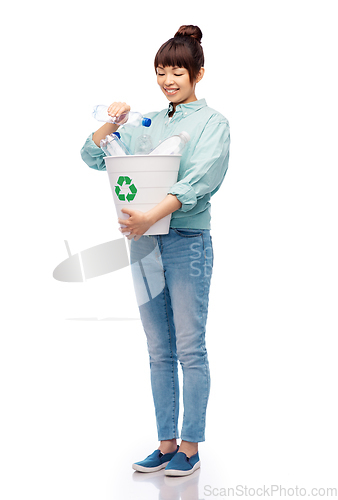 Image of smiling young woman sorting plastic waste