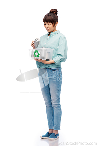 Image of smiling young asian woman sorting metallic waste