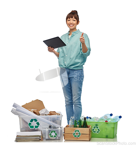 Image of smiling asian woman with tablet pc sorting waste