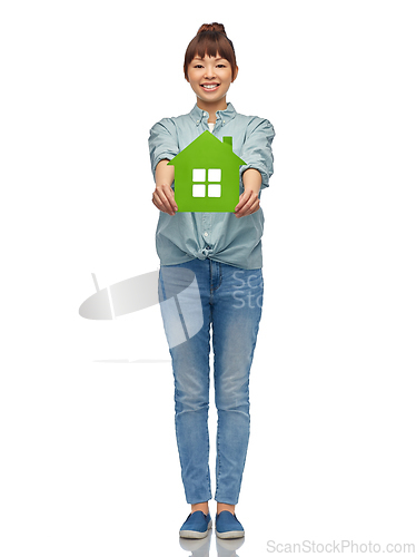 Image of smiling asian woman holding green house