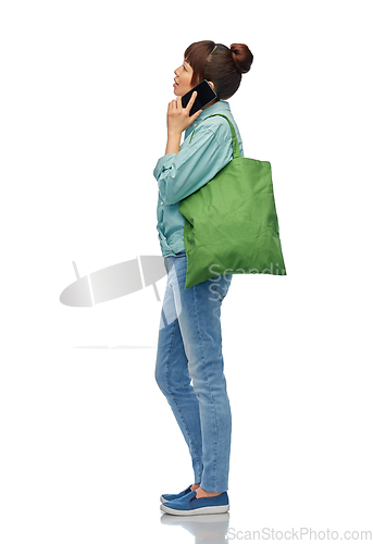 Image of woman with phone and reusable food shopping bag