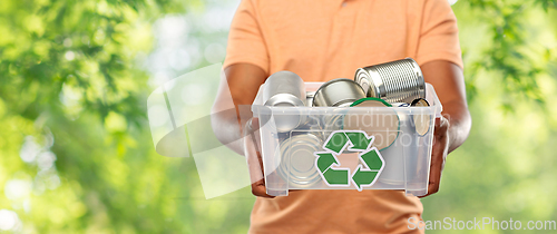 Image of close up of young man sorting metallic waste