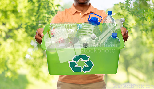 Image of close up of young man sorting plastic waste