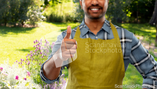 Image of indian male gardener showing thumbs up at garden