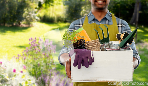 Image of indian gardener or farmer with box of garden tools