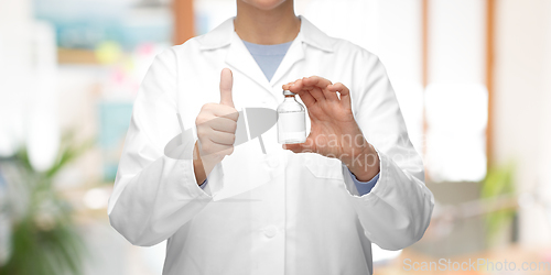 Image of close up of doctor with medicine showing thumbs up