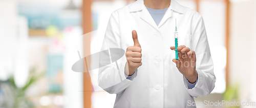 Image of close up of doctor with syringe showing thumbs up