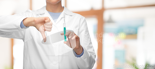 Image of close up of doctor with syringe shows thumbs down