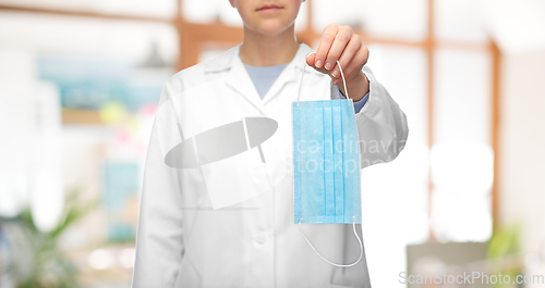 Image of female doctor showing medical mask