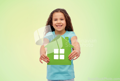 Image of smiling little girl holding green house icon