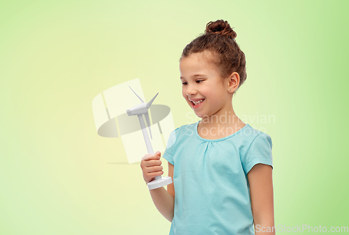 Image of smiling girl with toy wind turbine