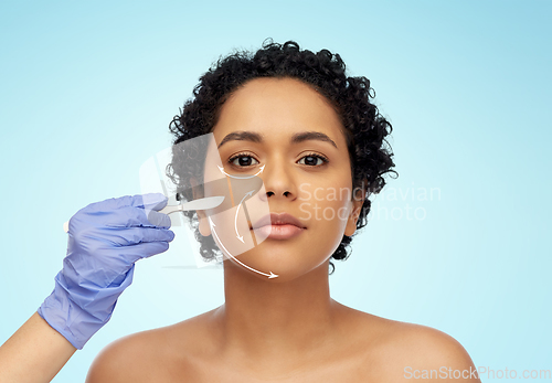 Image of african american woman and hand with scalpel knife