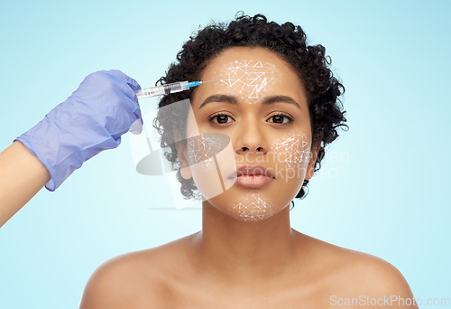 Image of face of african woman and hand with syringe