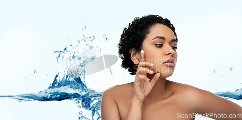 Image of young african american woman with moisturizer