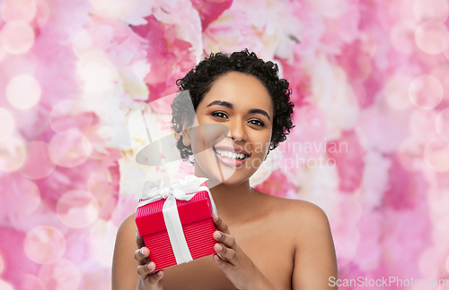 Image of portrait of young african american woman with gift