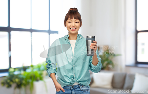 Image of woman with thermo cup or tumbler for hot drinks