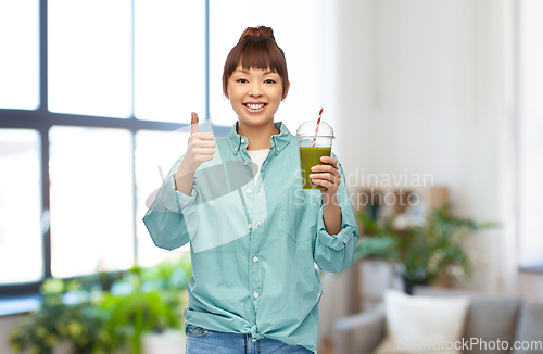 Image of happy smiling asian woman with can drink