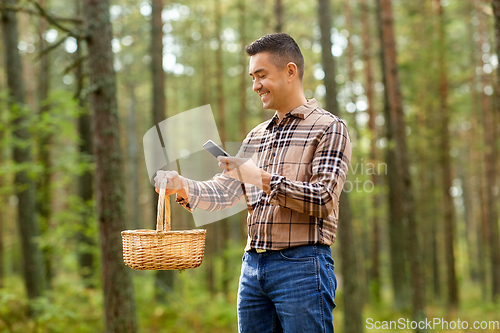 Image of man using smartphone to identify mushroom